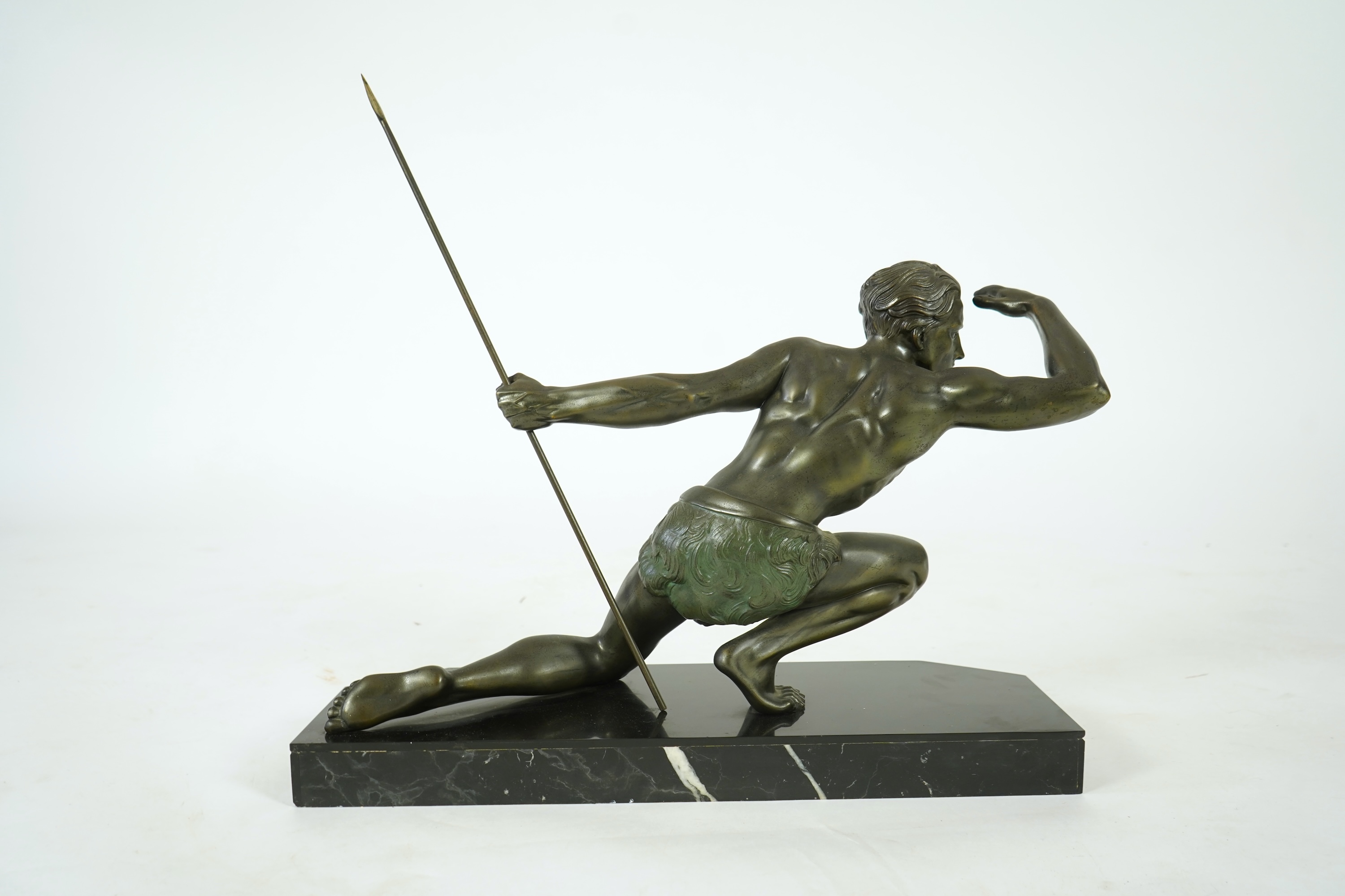 Manner of Jean de Roncourt (1869-1937) An Art Deco patinated bronze sculpture of a male hunter with spear on black marble stand